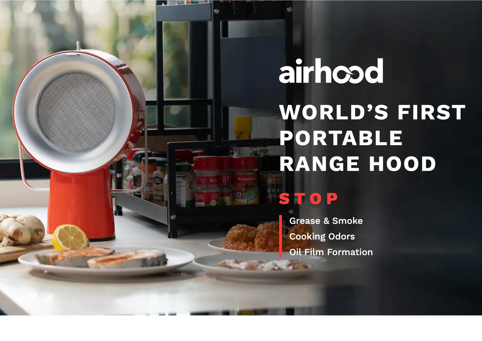 The airhood wordmark over the hero: the orange AirHood on a counter beside plated meals fills the left of the frame; right of it, World's First Portable Range Hood. STOP: Grease & Smoke, Cooking Odors, Oil Film Formation.