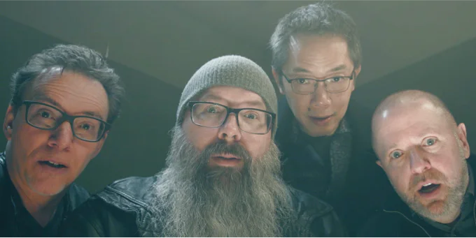 Four Hallmark Keepsake artists leaning into frame together.