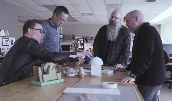 The Hallmark team reviewing a prototype around a studio table.