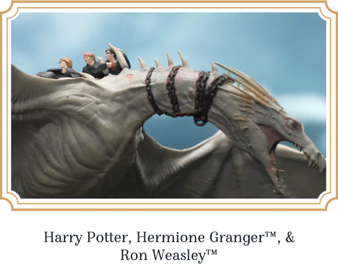 Harry Potter, Hermione Granger, and Ron Weasley sculpted riding the dragon, in a gold frame.