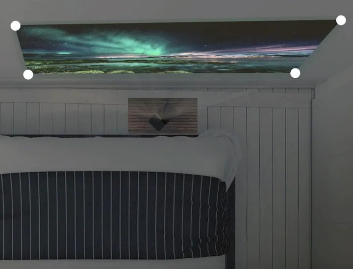 An aurora landscape projected on the wall above a bunk bed, a white dot marking each of its four corners