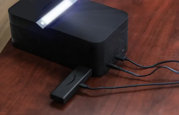 The U4's back panel on a wooden table, an Amazon Fire TV stick plugged into one of its ports.