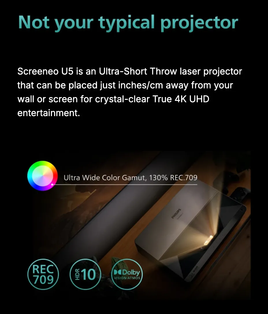 Not your typical projector. Screeneo U5 is an Ultra-Short Throw laser projector that can be placed just inches/cm away from your wall or screen for crystal-clear True 4K UHD entertainment. A color wheel marks an ultra-wide color gamut at 130 percent REC.709, beside REC709, HDR10 and Dolby Vision Atmos badges over the projector photographed on a wooden sideboard.